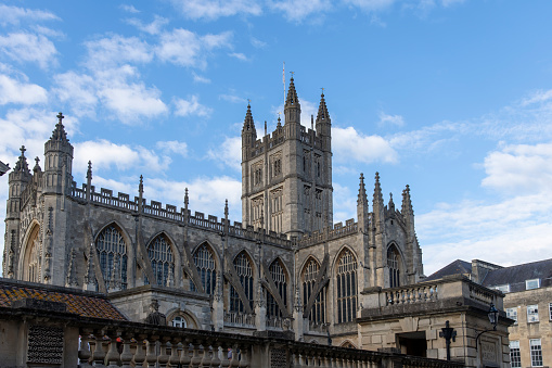Bath, Somerset, England-August 2022; Low angle view of outside façade of medieval Bath Abbey with a Victorian Gothic interior