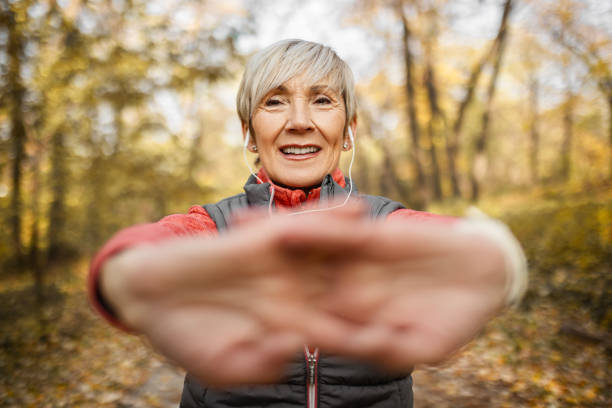 istock Senior woman in park stretching looking at camera 1490342278