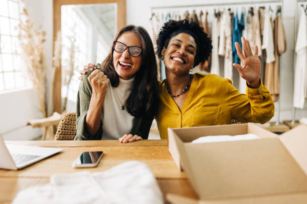 Female ecommerce business owners celebrating their success stock photo
