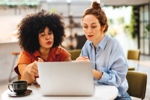 istock Professional women having a discussion as they work with a laptop 1490343694