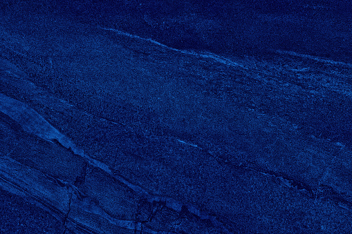 Dark blue grainy veins texture. Navy bright color textured surface. Indigo colour abstract background