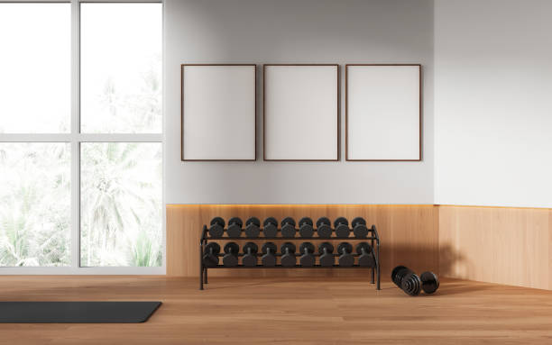 istock Stylish sport room interior with dumbbell rack and mat, mock up frames 1490347934