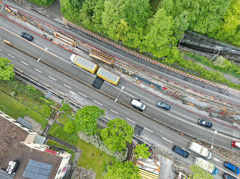 Top view of urban road with construction site and traffic on a cloudy spring morning at City of Zürich. Photo taken May 9th, 2023, Zurich, Switzerland.