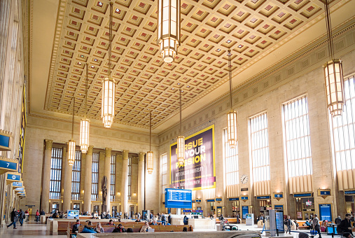 Philadelphia, USA - People in the imposing main hall of Philadephia's William H. Gray III 30th Street Train Station.