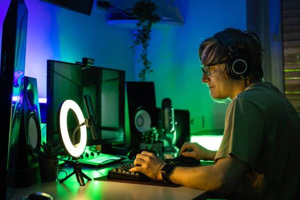 istock Man playing a video game in a room with high tech set up. 1490353494