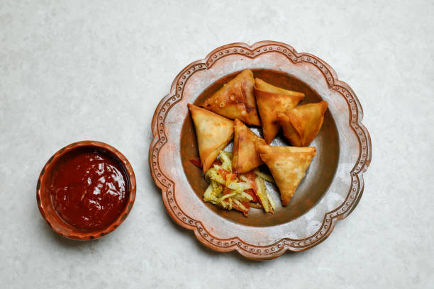 istock Crispy Samosa filled with chicken and vegetables with chilli sauce tomato ketchup served in dish isolated on table top view of indian, bangladeshi and pakistani street food 1490356245