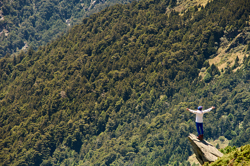 Hiker on the top of the mountain peak.