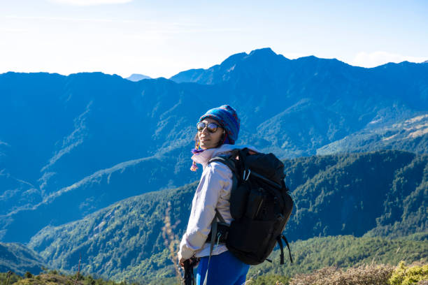 istock Hikers stand on top of a mountain looking at view. 1490358104