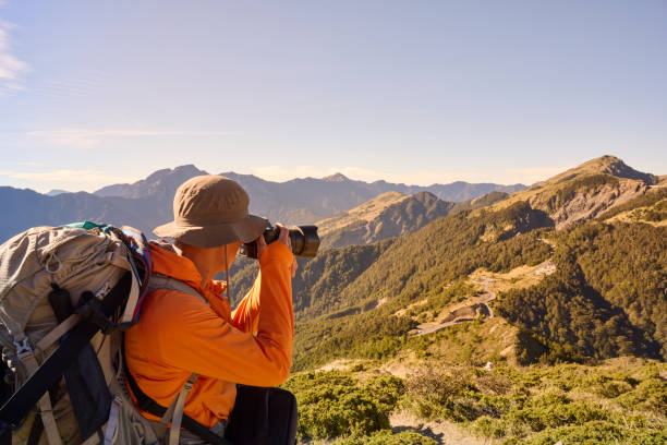 istock Mountain hiker taking photos on the mountain top. 1490359449