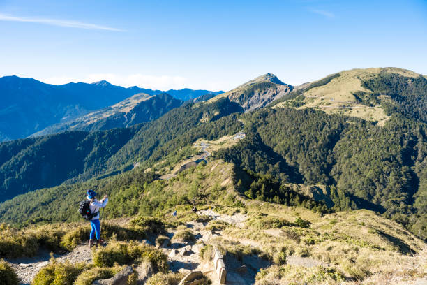 Mountain hiker taking photos on the mountain top.
