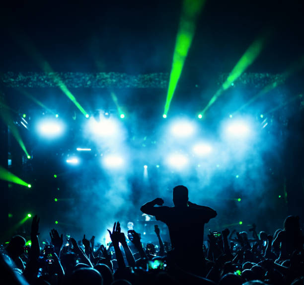 istock Large group of people at a concert party. 1490360608