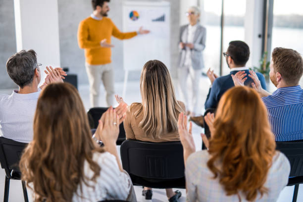 istock Entrepreneurs applauding on business presentation in board room. 1490364940