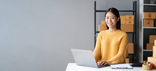 istock Portrait of young Asian small business owner working in her room while using laptop computer. Sme business concept. 1490365906
