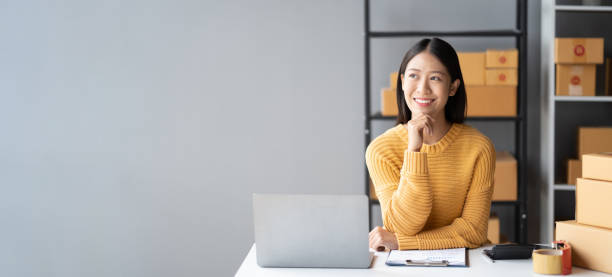 istock Portrait of young Asian small business owner working in her room while using laptop computer. Sme business concept. 1490366280