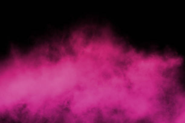 Pink powder explosion on black background. stock photo
