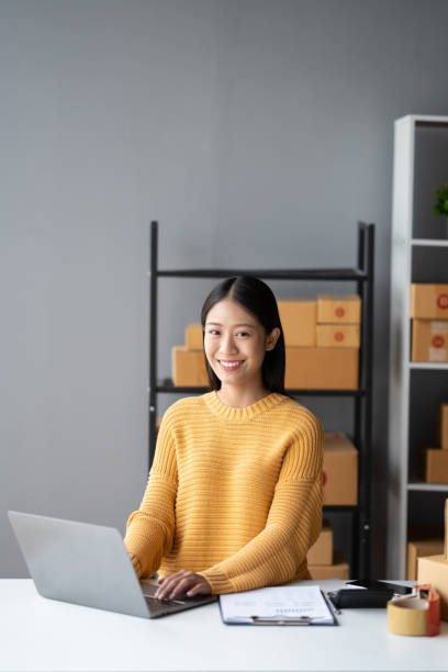 istock Portrait of young Asian small business owner working in her room while using laptop computer. Sme business concept. 1490367775