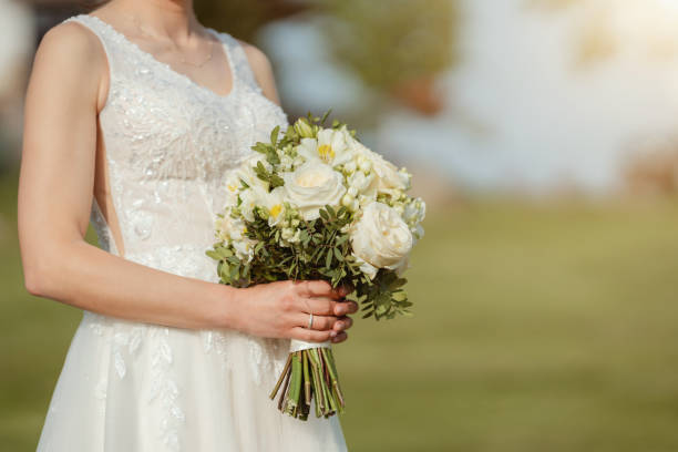 istock Mid section of unrecognizable bride holding wedding bouquet 1490372783