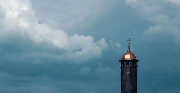 Church tower against dramatic sky background