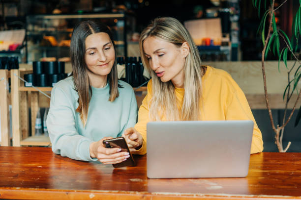istock Two businesswomen colleagues are discussing a project while sitting in a cafe. 1490375281