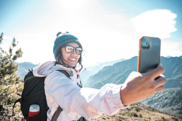 istock Friends with backpack taking selfie portrait on a mountain. 1490378357