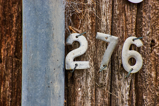 Image of Detail of number 276 on wood telephone pole