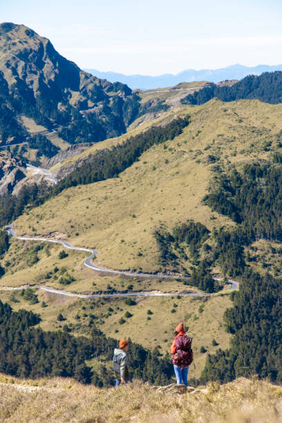 Hikers walking alone on top of a mountain.