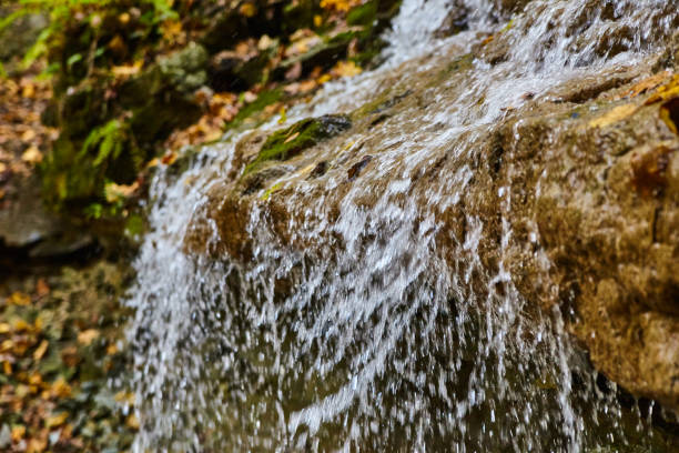 Image of Detail of waterfall water flowing over edge blurred