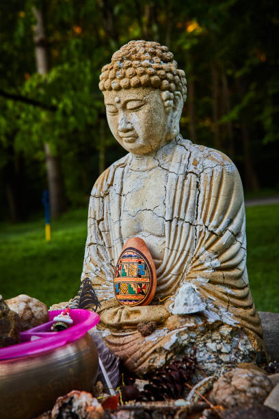 istock Donations surround old cracked Buddha statue 1490381879