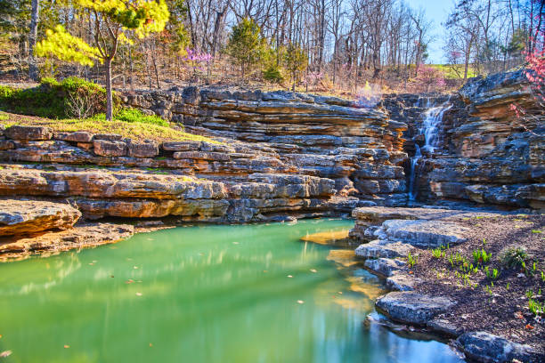istock Early spring view of waterfall through jagged rocks into majestic waters 1490382174