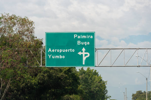 Highway signaling with different municipalities of Valle del Cauca. Colombia. Road sign indicating the direction of the municipality of Palmira and Buga and the Yumbo airport in Valle del Cauca. Colombia. palmira colombia stock pictures, royalty-free photos & images