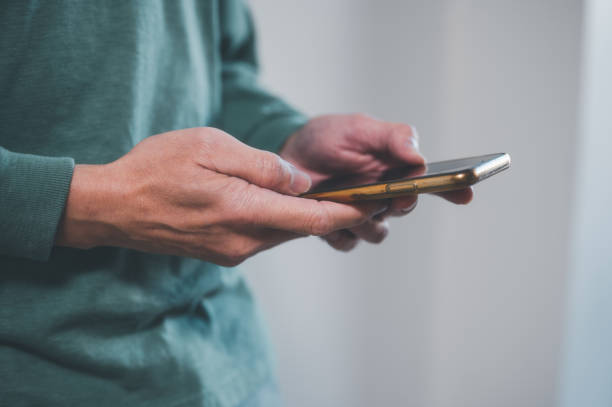 istock social media internet network connection concept, man hand holding texting message on screen mobile chatting friend ,search internet information .technology device contact 1490384250