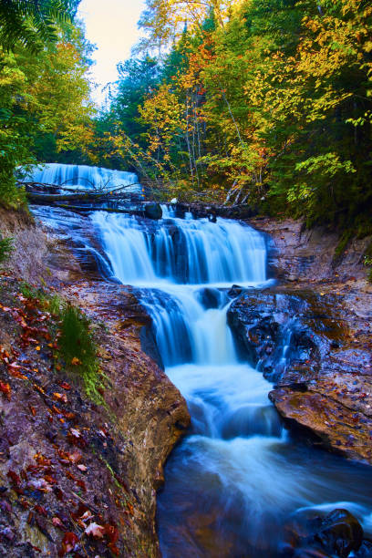istock Four-tiered waterfall with smooth flowing white water and nearly baren cliffs surrounding it 1490384716
