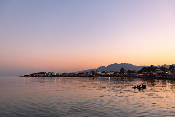 Beautiful sunset in Dahab seaside, cafes and orange sky in Dahab, Egypt