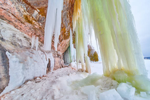 istock Giant sheets of icicles touching the ground next to cliffs 1490385370