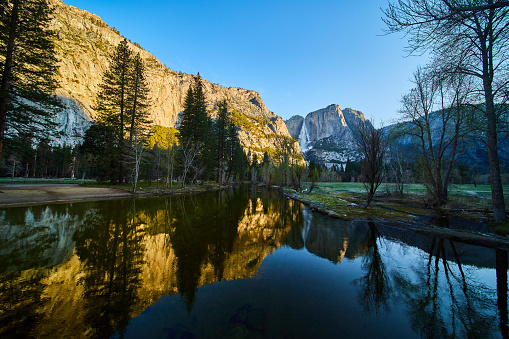 Image of Golden hour on river at Yosemite with Upper Falls in distance