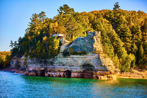 istock Gorgeous pictured rocks with teal water at edge and a forest atop the cliffs 1490386250