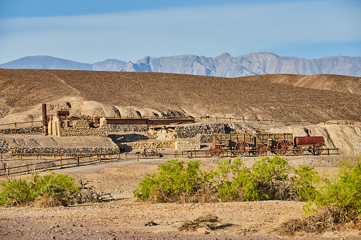 Image of Harmony Borax Works in Death Valley desert historical site surrounded by mountains