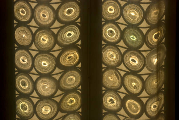 Shadows of Venetian glass window on a curtain