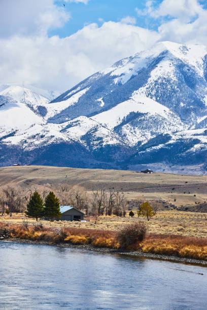 istock Huge snowy mountains next to river and fields 1490388894