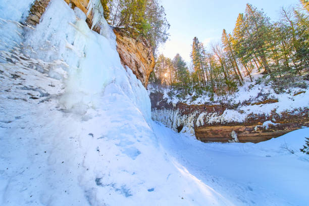 istock Ice and snow of frozen waterfall on cliffs with trees 1490388989