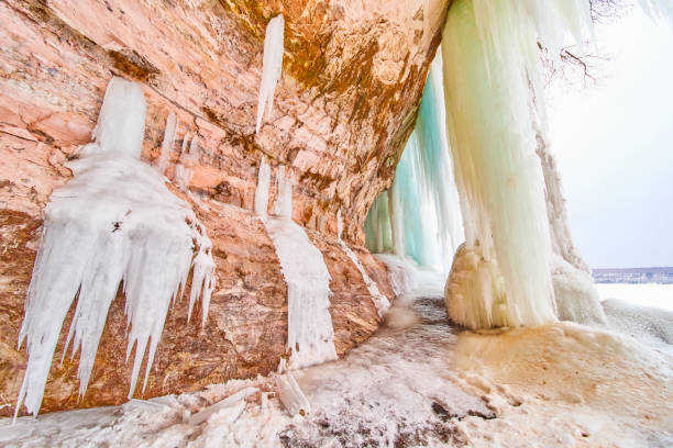 istock Ice formations and icicles forming on rocky cliffs in winter 1490389034