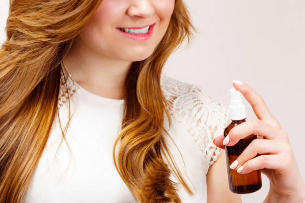 istock Woman applying hair cosmetic 1490393319