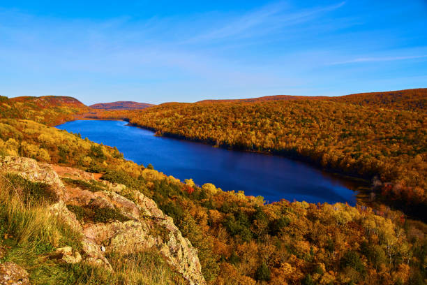 istock Lake in the Clouds with lake surrounded by unending forest in fall with boulder at bottom left 1490393652