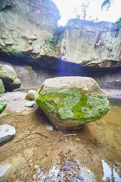 istock Large boulder with moss on in inside a dried-up waterfall basin 1490393900