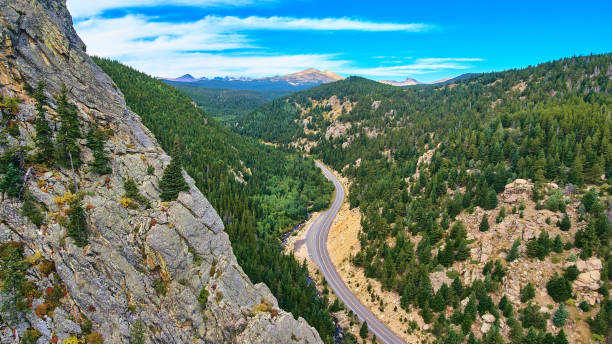 istock Large mountain edge next to canyon with road through valley 1490394235