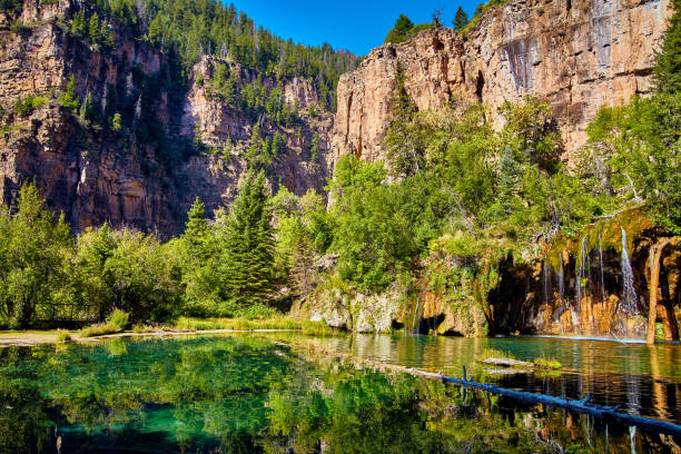 istock Large mountain view next to lake with waterfall 1490394253
