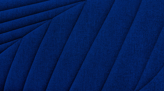 natural leaf pattern of sofa upholstery used as background in blue color tone. close up view of blue cotton woven sofa cushion fabric texture background. abstract template.