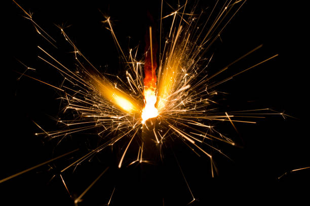 istock Lit sparkler shooting off sparks in the night 1490395660