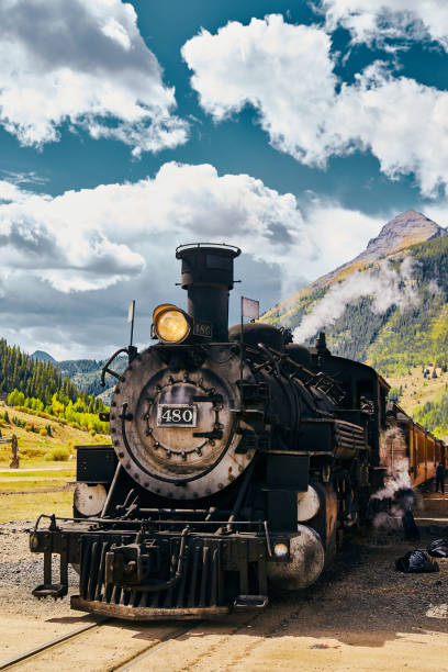 istock Locomotive coal train in midwest mountains with large clouds 1490396250