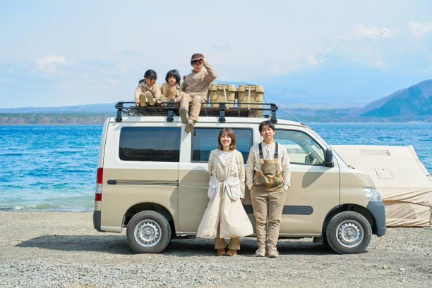 Camper and family enjoying the outdoors Camper and family enjoying the outdoors by the lake happy car asian stock pictures, royalty-free photos & images